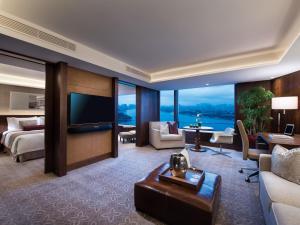 a hotel room with a bed and a television at White Swan Hotel in Guangzhou
