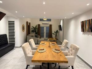 a dining room with a wooden table and chairs at Beach Retreat on Front Street in Philipsburg +7 photos