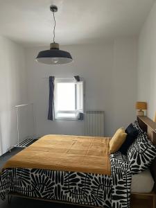 a bedroom with a bed and a window at Casa Luna 23 in Monopoli