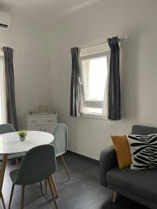 a living room with a table and a couch and a window at Casa Luna 23 in Monopoli +10 photos