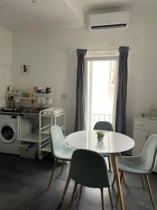 a kitchen with a table and chairs and a window at Casa Luna 23 in Monopoli