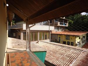 an outside view of a building with a swimming pool at Residencial Villa Cantareira in Caieiras