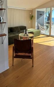 a living room with a table and a couch at True Atmosphere With Sea View And Beach in Idestrup +32 photos