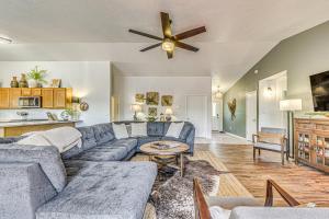 a living room with a couch and a ceiling fan at Charming Ruidoso House with Deck and Mountain Views! in Ruidoso