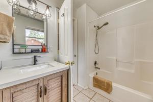 a bathroom with a sink and a mirror and a tub at Charming Ruidoso House with Deck and Mountain Views! in Ruidoso +26 photos