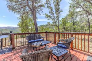 a patio with chairs and a table on a deck at Charming Ruidoso House with Deck and Mountain Views! in Ruidoso