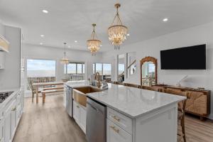 a kitchen with a counter top and a dining room at Oceanfront Luxury Private Steps to Beach New in Oak Island