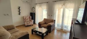 a living room with a couch and a chair at View Apartment in Krašići