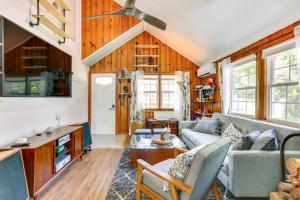 a living room with a couch and a ceiling fan at All-Season Vernon Township Lake House Retreat! in Vernon Township
