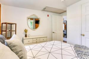 a living room with a mirror and a table at All-Season Vernon Township Lake House Retreat! in Vernon Township