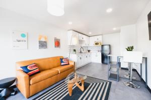 a living room with a couch and a kitchen at Heights House Hotel - Houston Heights Downtown, an Ascend Collection Hotel in Houston
