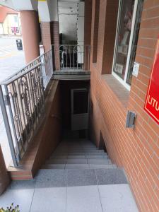 a stairway in a brick building with a balcony at Mieszkanie do wynajęcia w Centrum in Olecko