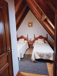 una camera con due letti in mansarda di Ostau ERA NHEUADA VALLE DE ARAN ad Aubert