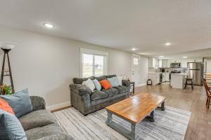 a living room with a couch and a table at Less Than 3 Mi to Double JJ Resort Home with Large Yard! in Rothbury