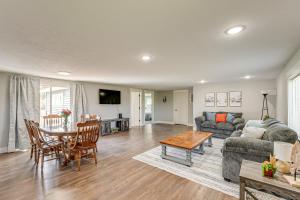 a living room with a couch and a table at Less Than 3 Mi to Double JJ Resort Home with Large Yard! in Rothbury