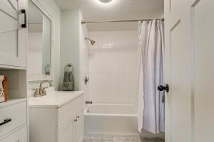 a white bathroom with a shower and a sink at Less Than 3 Mi to Double JJ Resort Home with Large Yard! in Rothbury +17 photos