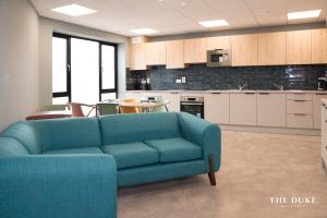 a living room with a blue couch in a kitchen at The Duke Maynooth in Maynooth +12 photos