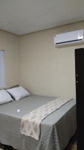 a bedroom with a bed and a air conditioner on the wall at Casa na lagoa do Paraíso- Villa Bem Estar in Jericoacoara