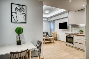 a kitchen and living room with a table and chairs at Virginia Haven 2 in Chios