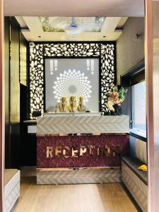 a hotel lobby with a reception counter with a sign at Hotel Ram Ghar - Near Mathura Junction Railway Station in Mathura