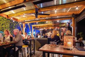 a group of people sitting at tables in a restaurant at Townhouse Hotel in Wagga Wagga