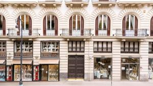 a large white building with windows and balconies at G Cave 125 Boutique Apartment in Palermo