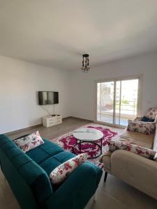 a living room with a couch and a table at Amwaji in El Alamein