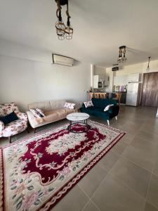 a living room with a couch and a table at Amwaji in El Alamein
