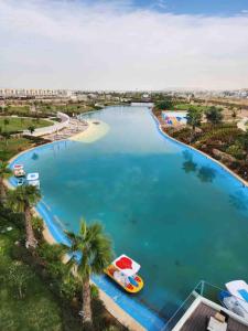 an aerial view of a lake with a boat in it at Damac Hills 2 Villa Pool Front + Waterpark Access in ‘Ūd al Bayḑāʼ