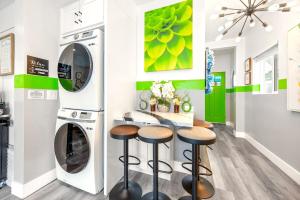 a laundry room with a washer and dryer and stools at D- Hip NoHo Haven Hot Tub - Family - Parking in North Hollywood