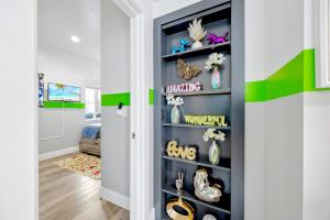 a room with a blue and green wall with shelves at D- Hip NoHo Haven Hot Tub - Family - Parking in North Hollywood +34 photos