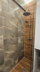a shower with a glass door in a bathroom at Black and white suites 2 in Thessaloniki +6 photos