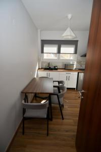 a kitchen with a table and chairs in a kitchen at Black and white suites 2 in Thessaloniki