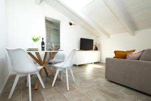 Assisi Panorama Luxe في أسيسي: غرفة معيشة مع طاولة وكراسي وأريكة