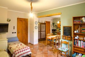 a room with a bed and a table and a chalkboard at Bay Cottage in Verrua Savoia