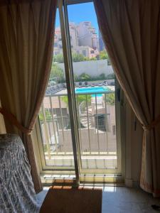 a bedroom with a large window with a view of a pool at La Palme studio in Cannes