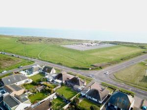 an aerial view of a house next to the ocean at Bayview Cottage in Bournemouth