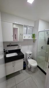 a bathroom with a toilet and a sink and a shower at Aline Duque 308 no Centro de Porto by La Playa in Porto De Galinhas