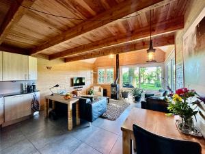 a kitchen and living room with a couch and a table at De Boase in Voorthuizen