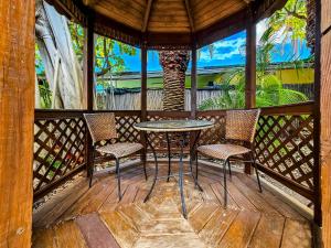 a table and two chairs on a wooden porch at Atlantis House Suites in Key West