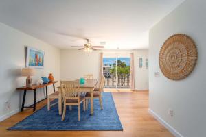 a dining room with a table and chairs and a ceiling fan at Our Happy Place in Sugarloaf Shores