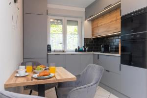 a kitchen with a wooden table with food on it at Becky Apartman in Komló