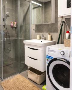a bathroom with a washing machine and a washer at Apartman Sara Trebinje in Trebinje