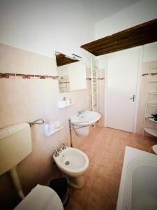 a bathroom with a white toilet and a sink at La camera a due passi dal mare in San Terenzo