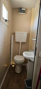 a small bathroom with a toilet and a sink at STELLA MARINA campling in Casa Franciana