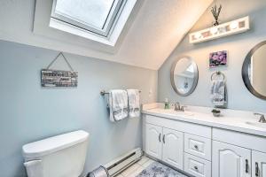 a bathroom with a toilet and a sink and a window at Mount Holly Vacation Rental with Hot Tub! in Mount Holly Heights +25 photos
