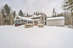 a house with snow on the ground in front of it at Mount Holly Vacation Rental with Hot Tub! in Mount Holly Heights