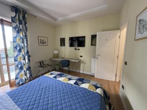 a bedroom with a blue bed and a desk at Frida in San Giorgio a Cremano