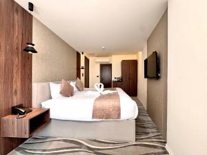 Postel nebo postele na pokoji v ubytování New MerryLand Hotel