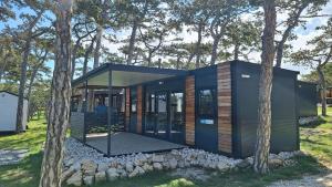 a modern house in the middle of trees at Green Hill Mobile Home in Ražanac +17 photos